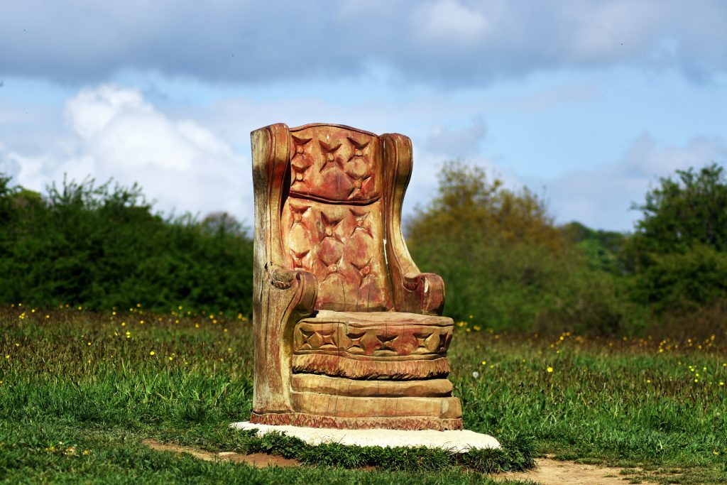 Close-up of a carved statue or a serene object representing quiet awareness in a peaceful space.